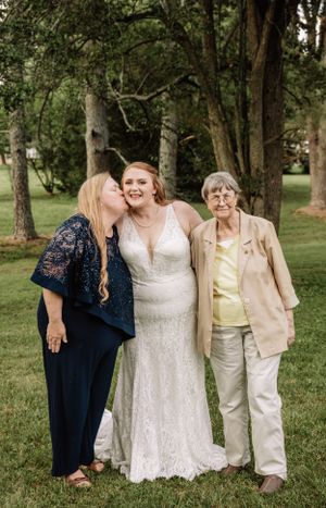 Wedding party members share laughs during casual outdoor photo session.