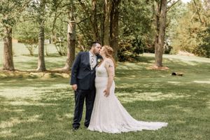A couple shares an intimate moment during their outdoor wedding photoshoot.