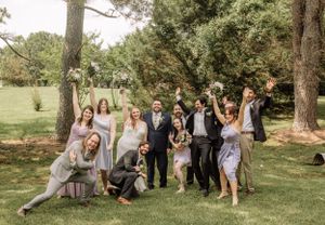 Bridal party creates fun, informal portraits in natural outdoor setting.