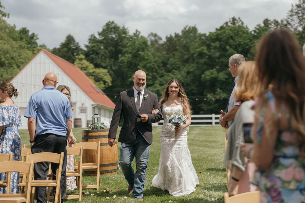 A series of outdoor wedding moments captured at a rustic countryside venue with horses and a wooden barn in view.