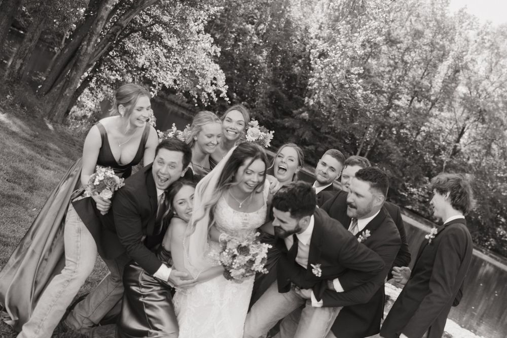 A black and white photo collage showing a wedding party posing together outdoors in formal attire.