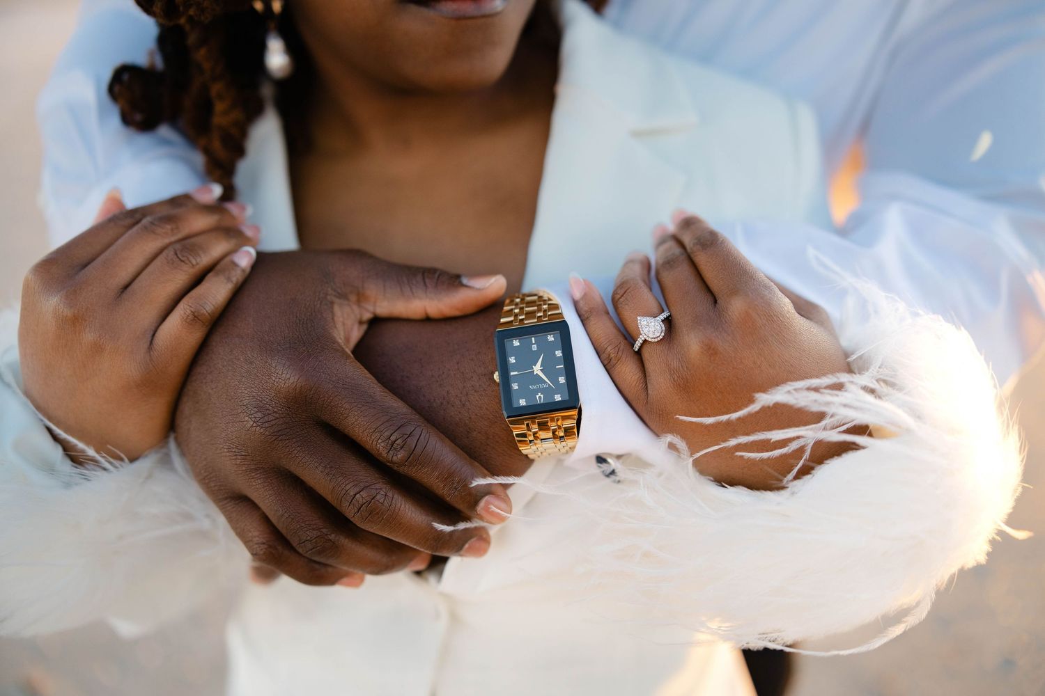 Close-up of hands and watch during a wedding day moment.