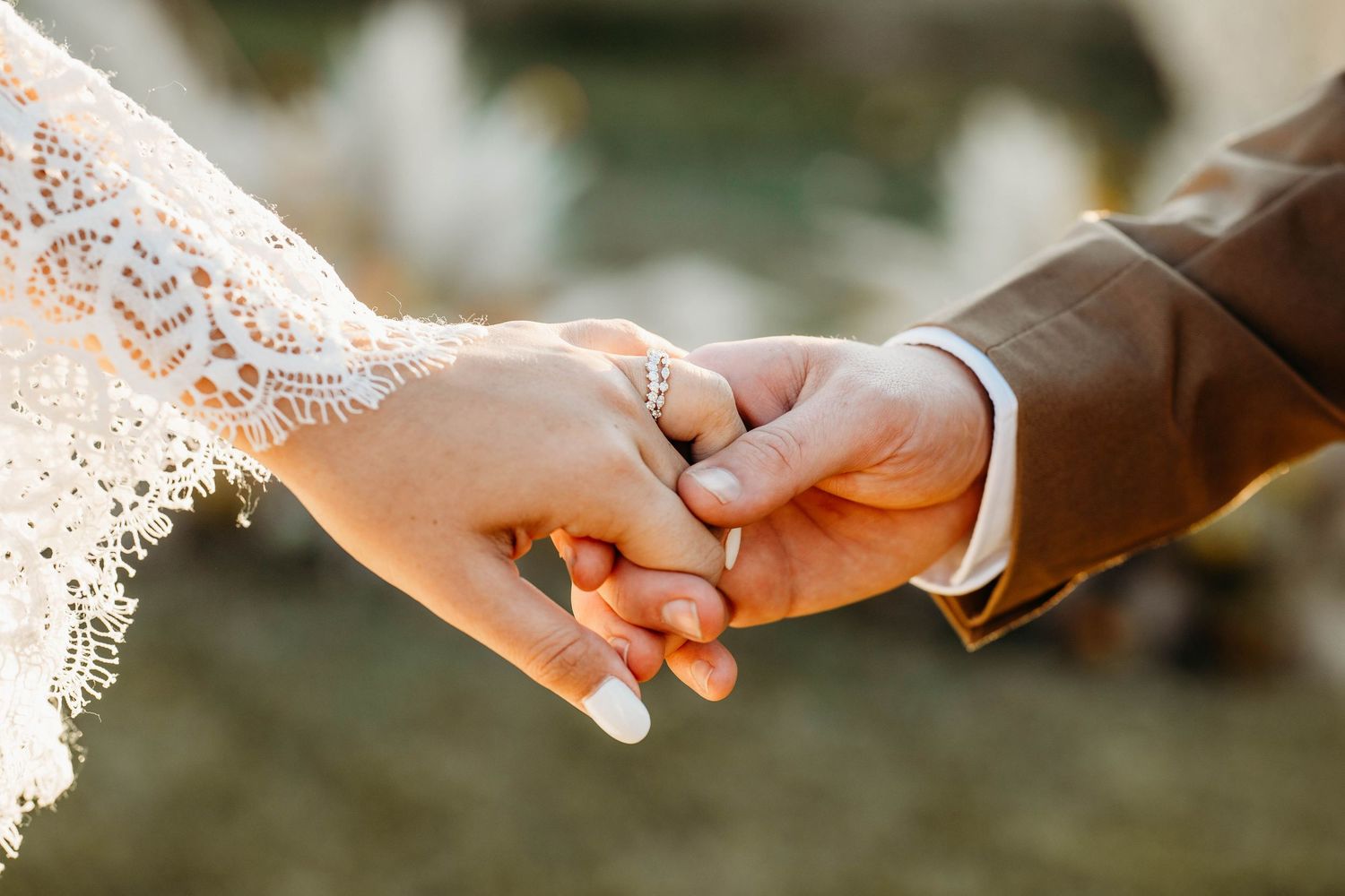 Bride and groom holding hands during a wedding ceremony.