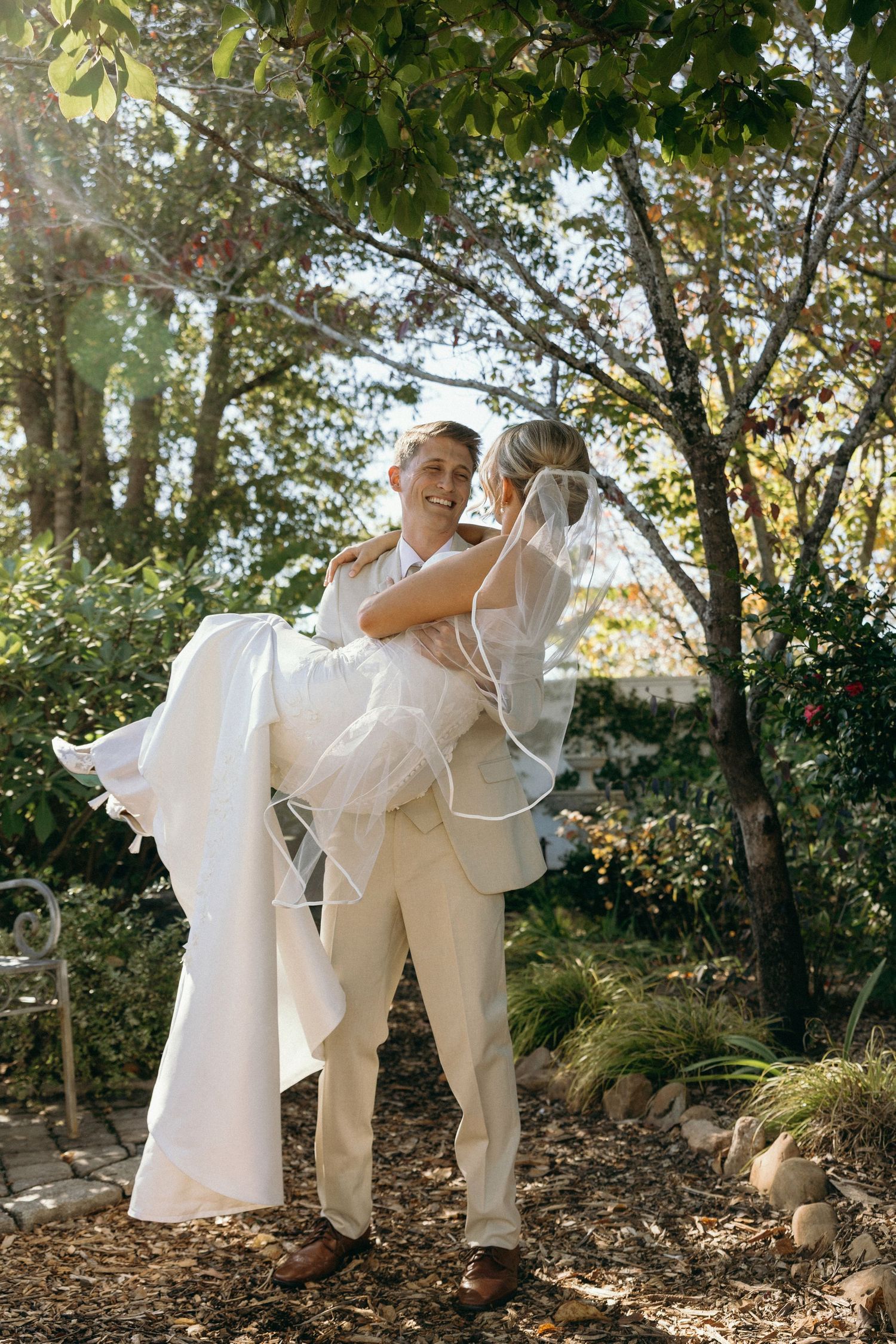 A photograph of a bride and groom on their wedding day in the garden for portraits at Lillian Gardens in Newnan, Georgia