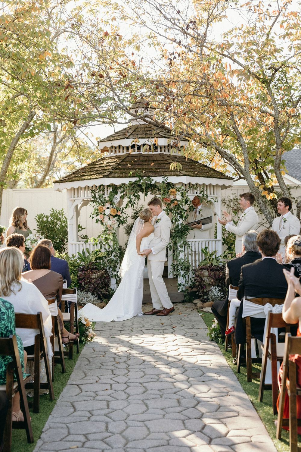 The first kiss at an outdoor garden wedding ceremony at Lillian Gardens in Newnan, Georgia