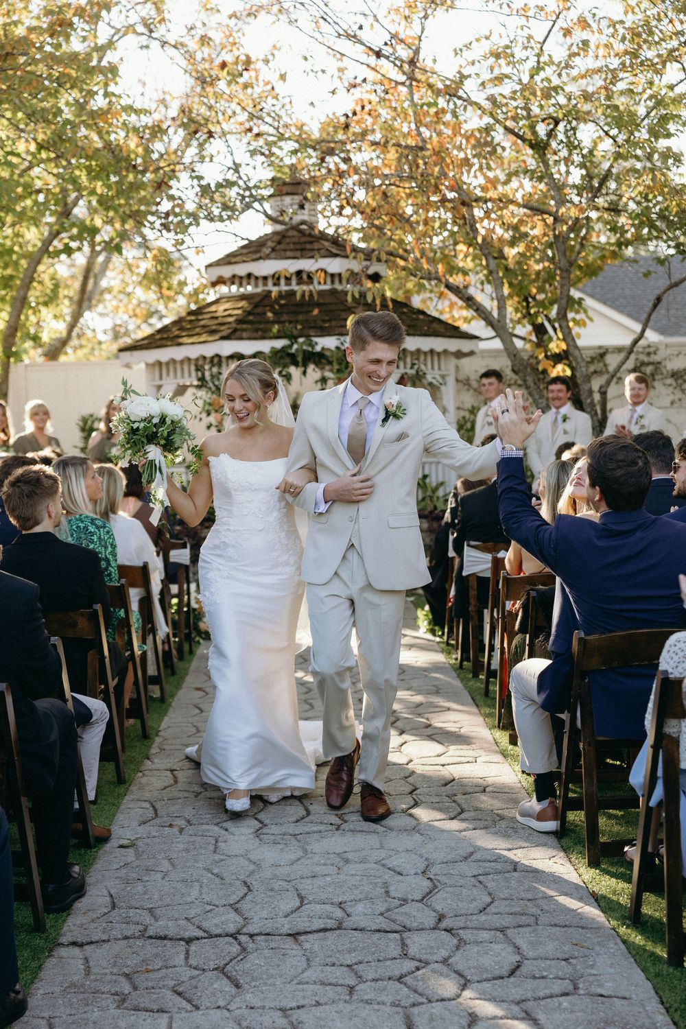 A couple walks down ceremony aisle at Lillian Gardens in Newnan, Georgia