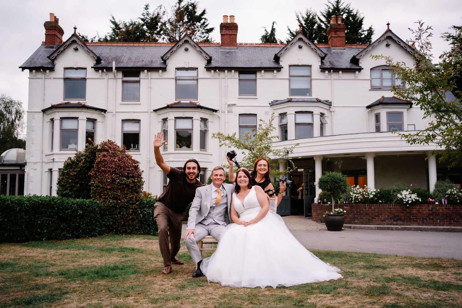 Couple sat with Megan and Jordan from Bon Amour Weddings enjoying photo roulette together at Southdowns manor