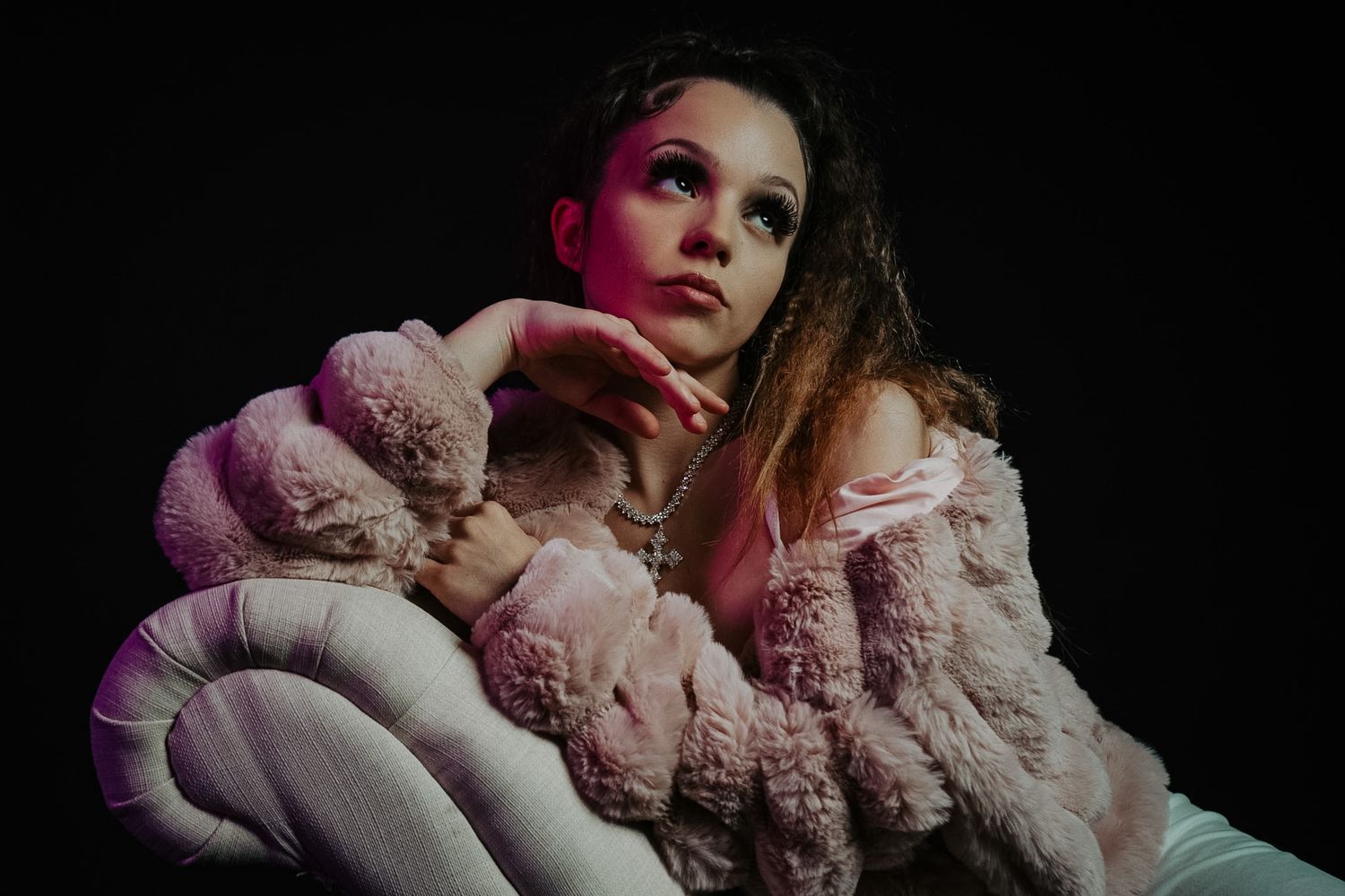 A series of fashion portraits showing someone in a leather jacket and white shirt striking dynamic poses against a gray backdrop.
