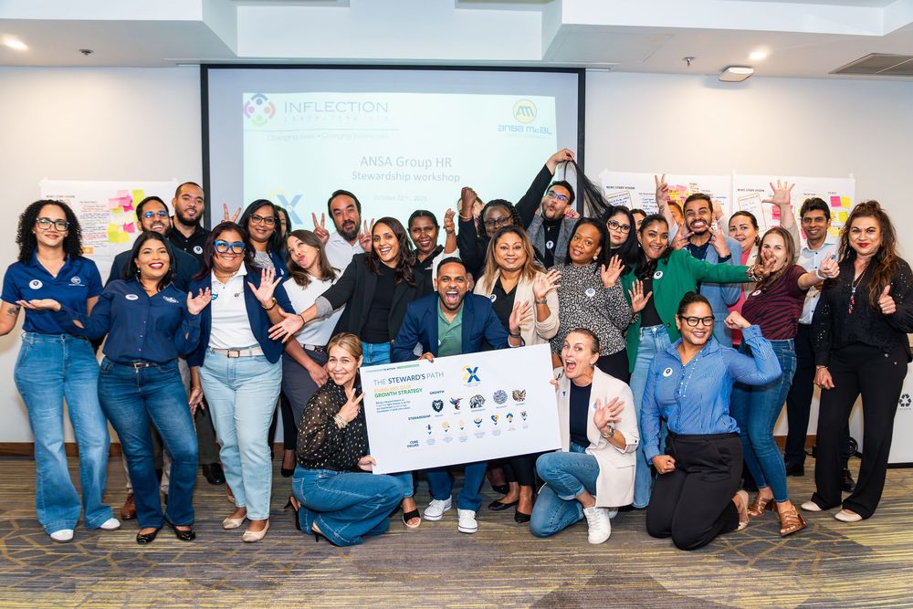 Large group celebrating together during a corporate event and group photo.