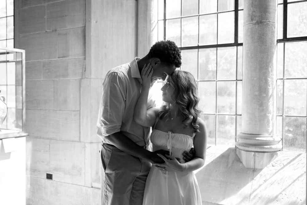A series of romantic silhouettes of a couple kissing against sunlit windows in an elegant indoor setting.