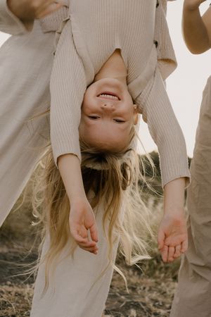 A serene scene in tall grass with a white sweater and flowing blonde hair caught in gentle motion.