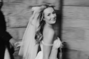 Black and white motion blur photo capturing movement and energy at a wedding celebration.