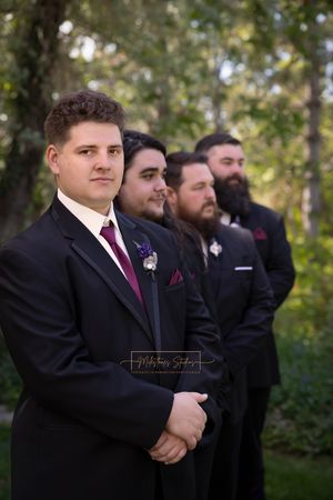 focus on groom with groomsmen in background
