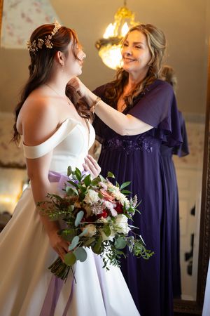 mother of the bride helping her
