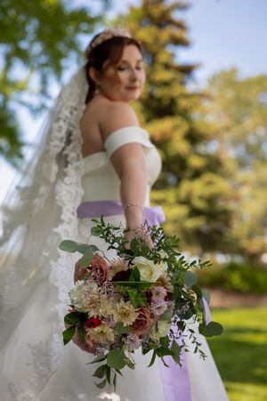 bridal bouquet in focus bride looking down at bouquet