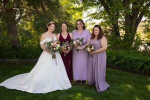 bride with bridesmaids wearing red and purple