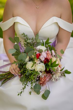 image of bride torso/dress and holding bridal bouquet