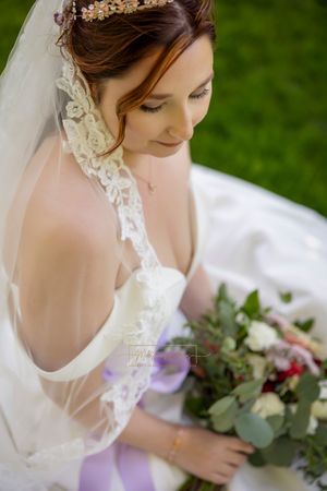 bride looking at bouquet taken from a high level