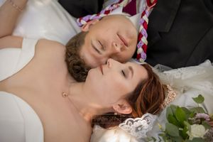 bride and groom lying down