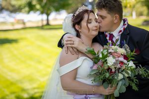 groom kissing bride's cheek