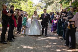 bride and groom walking through bubble aisle