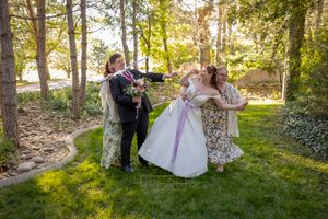 fun photo of bride and groom and family