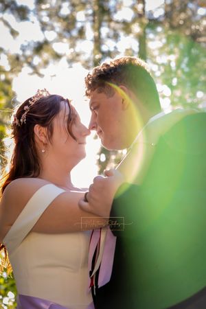 close up bride and groom portrait with natural sun flare