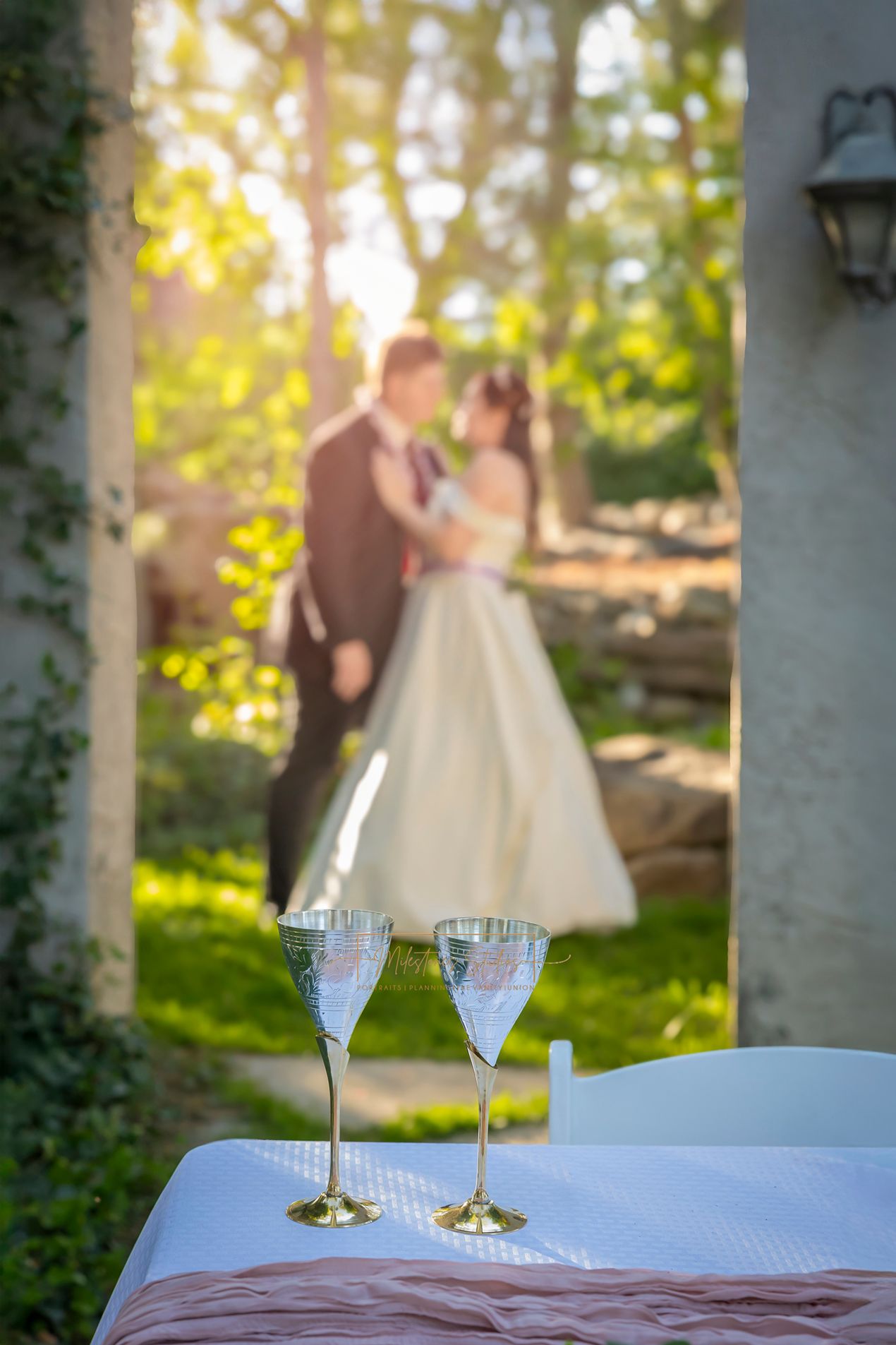 Wedding @ Wild Rose Manor Couple in background silver goblets in focus