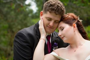 bride hand on groom's face eyes closed portrait