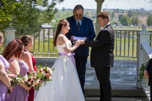 bride putting ring on groom's finger