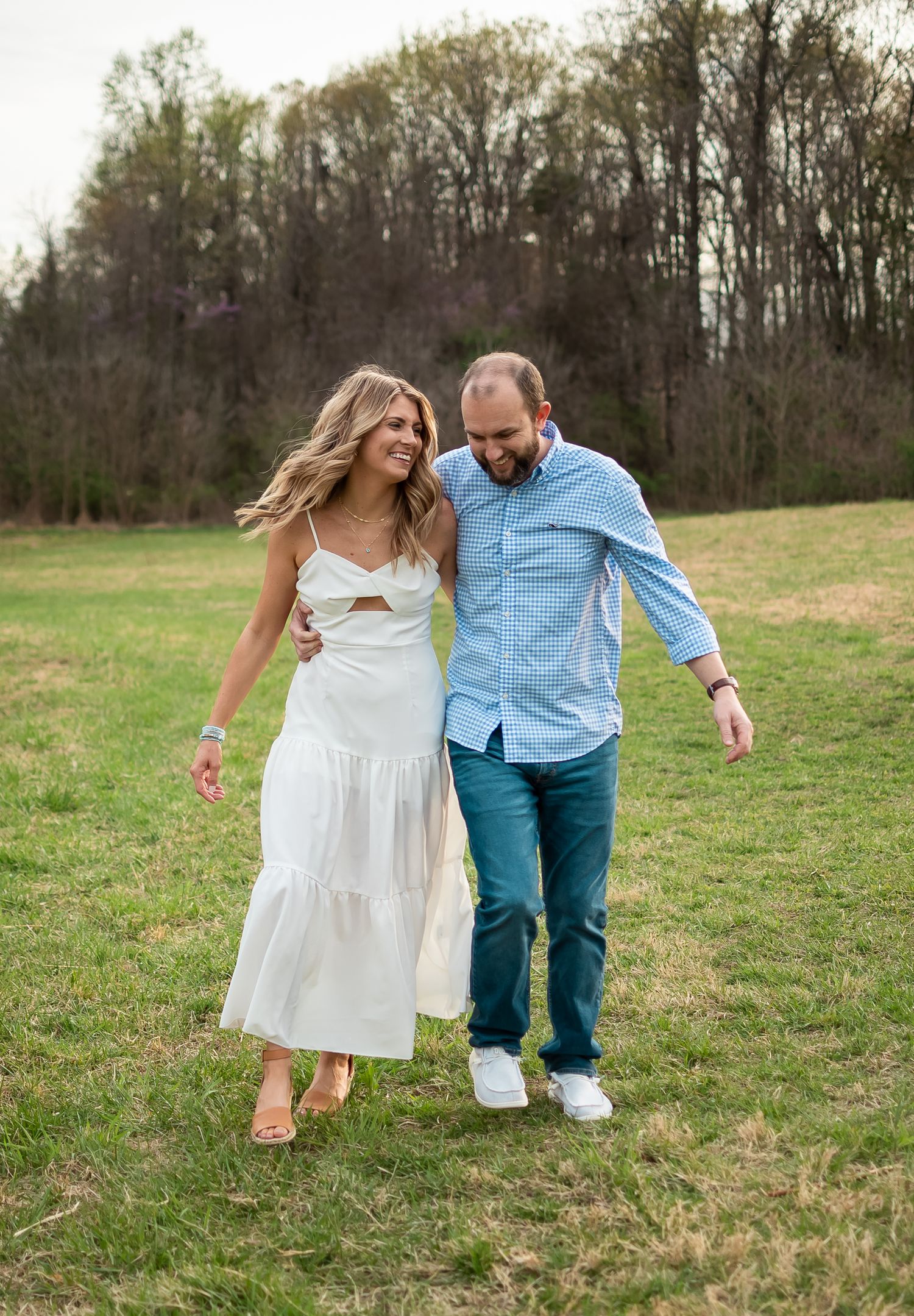 couple posed in a field for a couples photo session