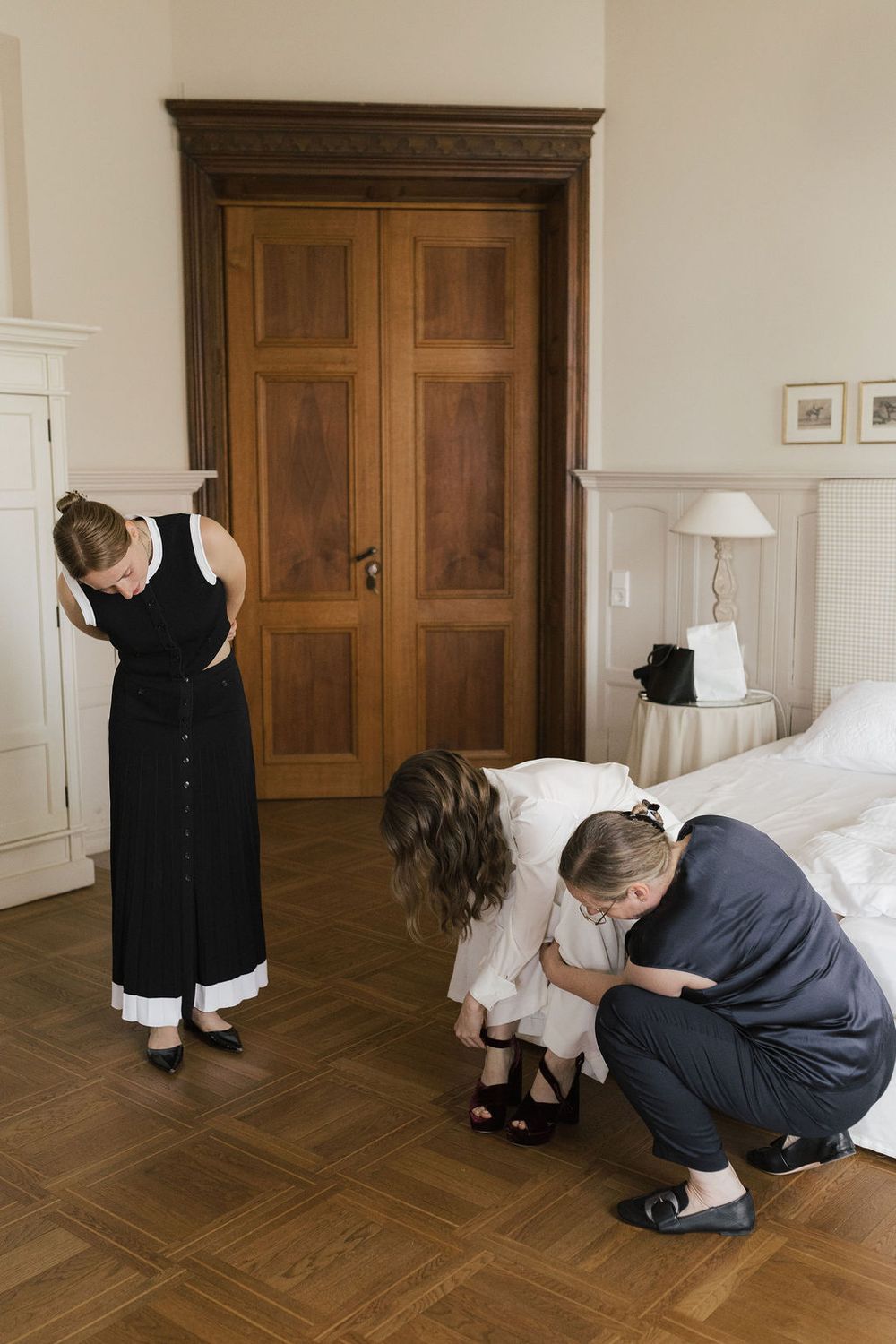 A sequence of photos showing someone in formal attire bending down to adjust their shoes on a hardwood floor.