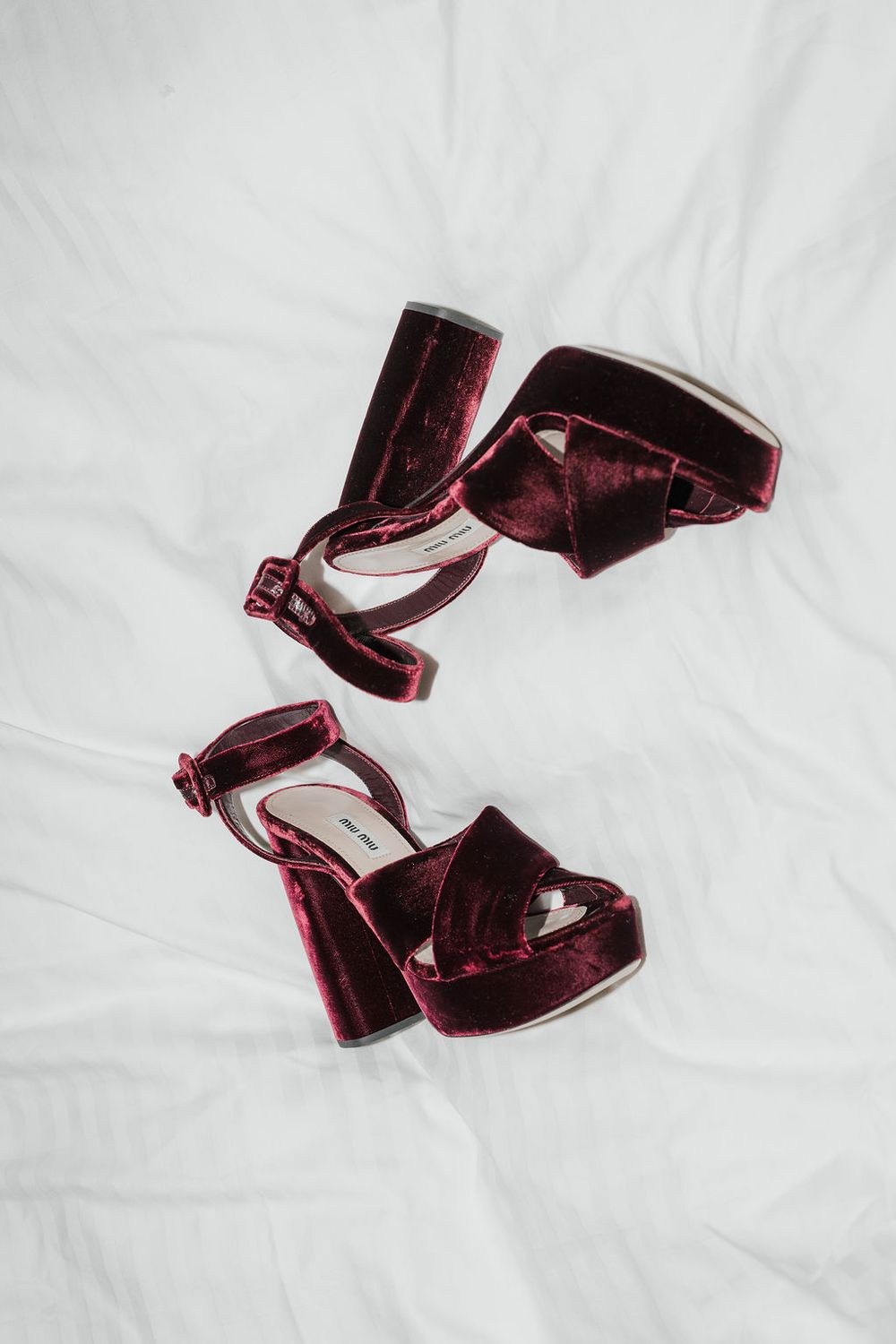 Burgundy velvet heeled shoes displayed on a white background in various angles.