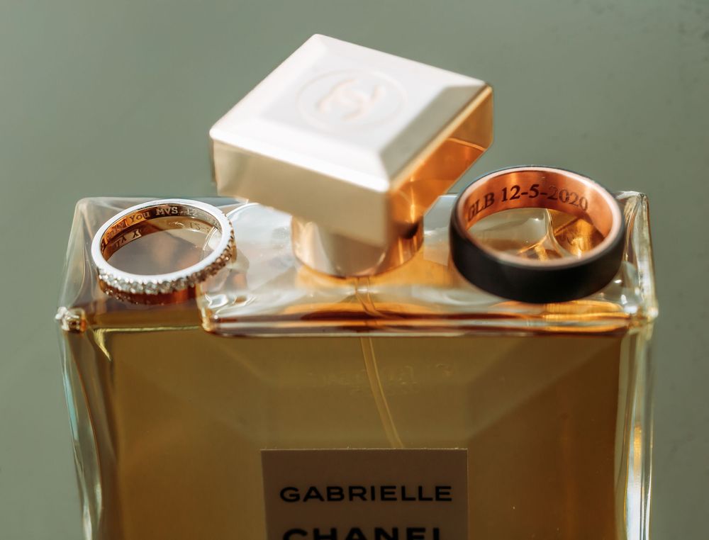 Luxury perfume bottle of Chanel Gabrielle fragrance photographed from multiple angles in warm lighting.