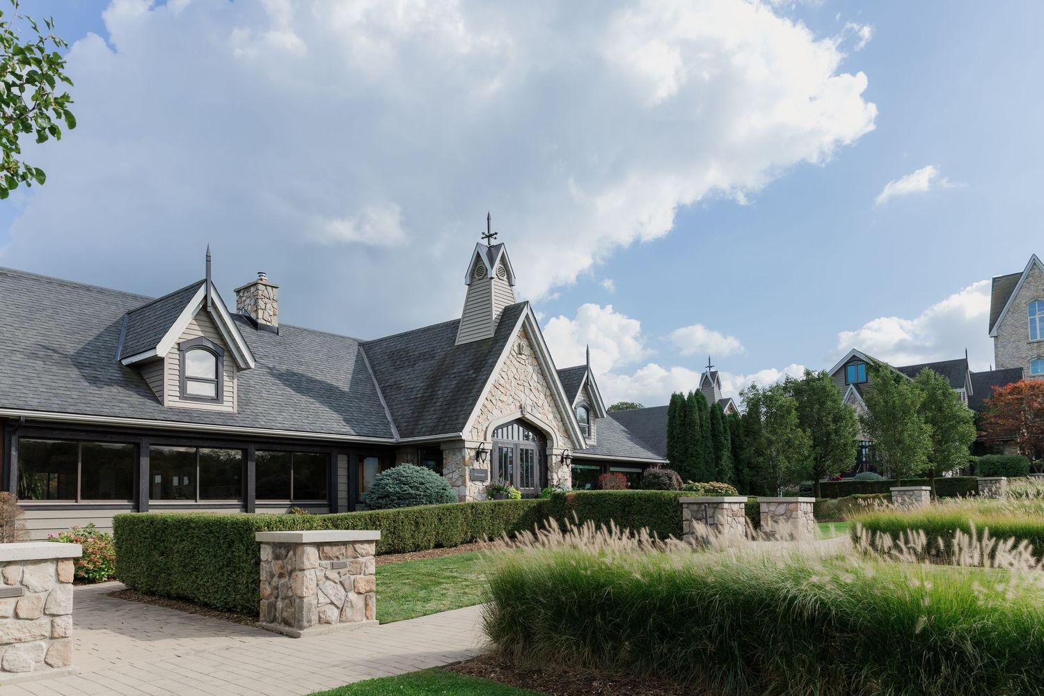 Elegant stone winery building with Gothic architecture features and landscaped gardens at Vineland Estates Winery.