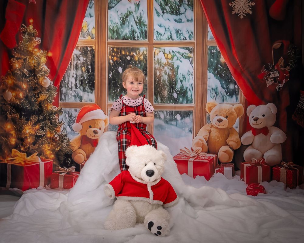 A cozy Christmas scene with teddy bears, red curtains, and snowy windows decorated with festive holiday ornaments.