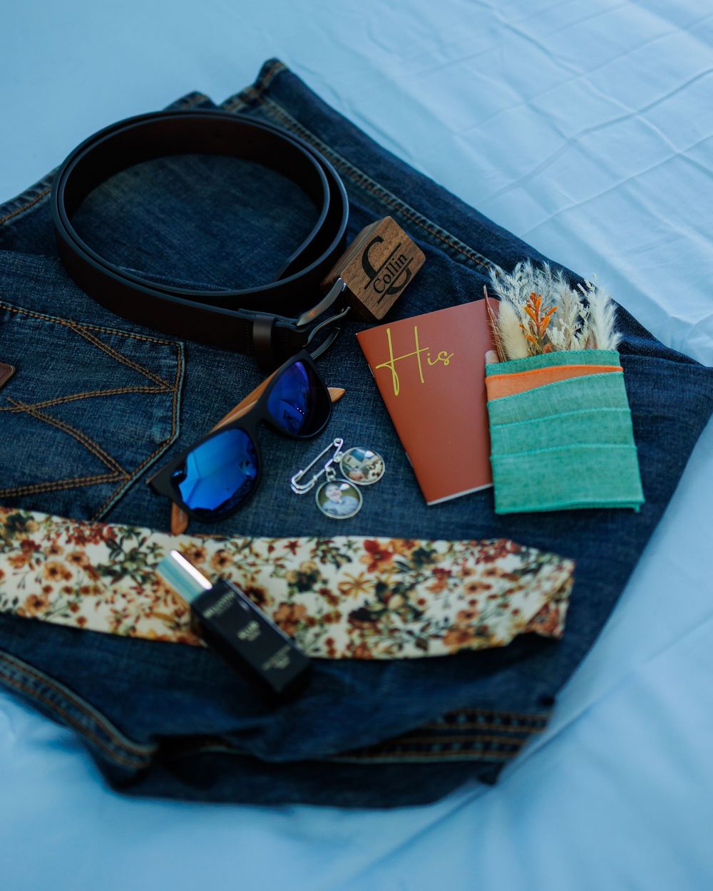 Denim jeans with wallet, keys, and accessories laid out in a sequence showing different angles and arrangements.