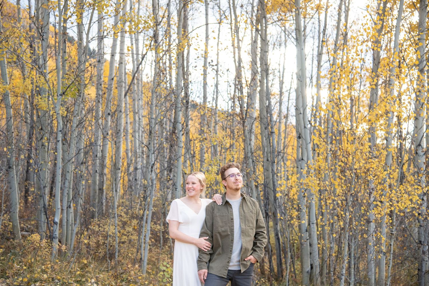Vail engagement photographer captures moody couple with a fall background of yellow leaves on aspen trees