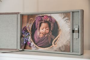 Modern photography studio wall display featuring framed portrait artwork in gray tones.