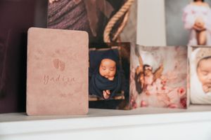 Professional photography portfolio display with multiple framed prints in soft tones.