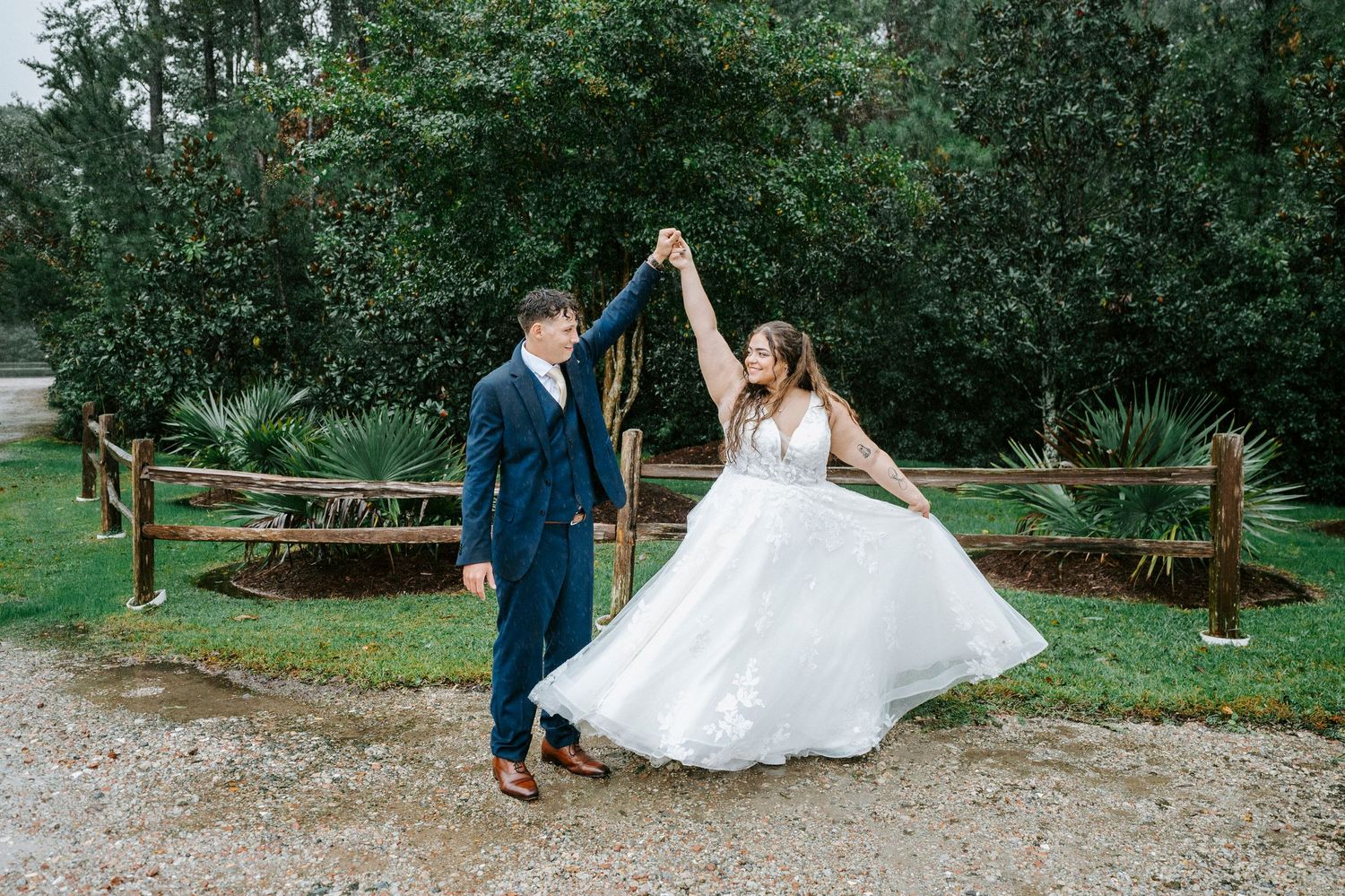 A couple in formal wedding attire poses together in a lush garden setting during their special celebration.