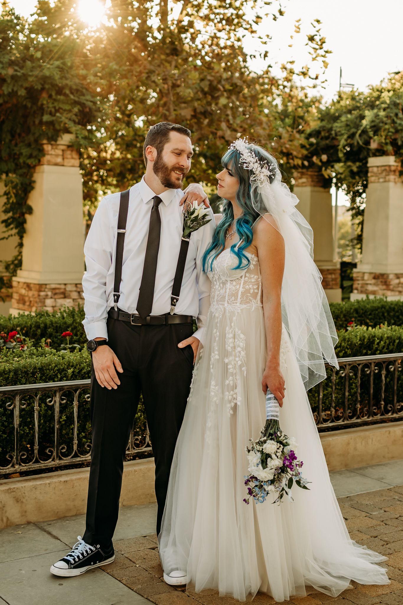 Couple staring at each other, smiling in a park.