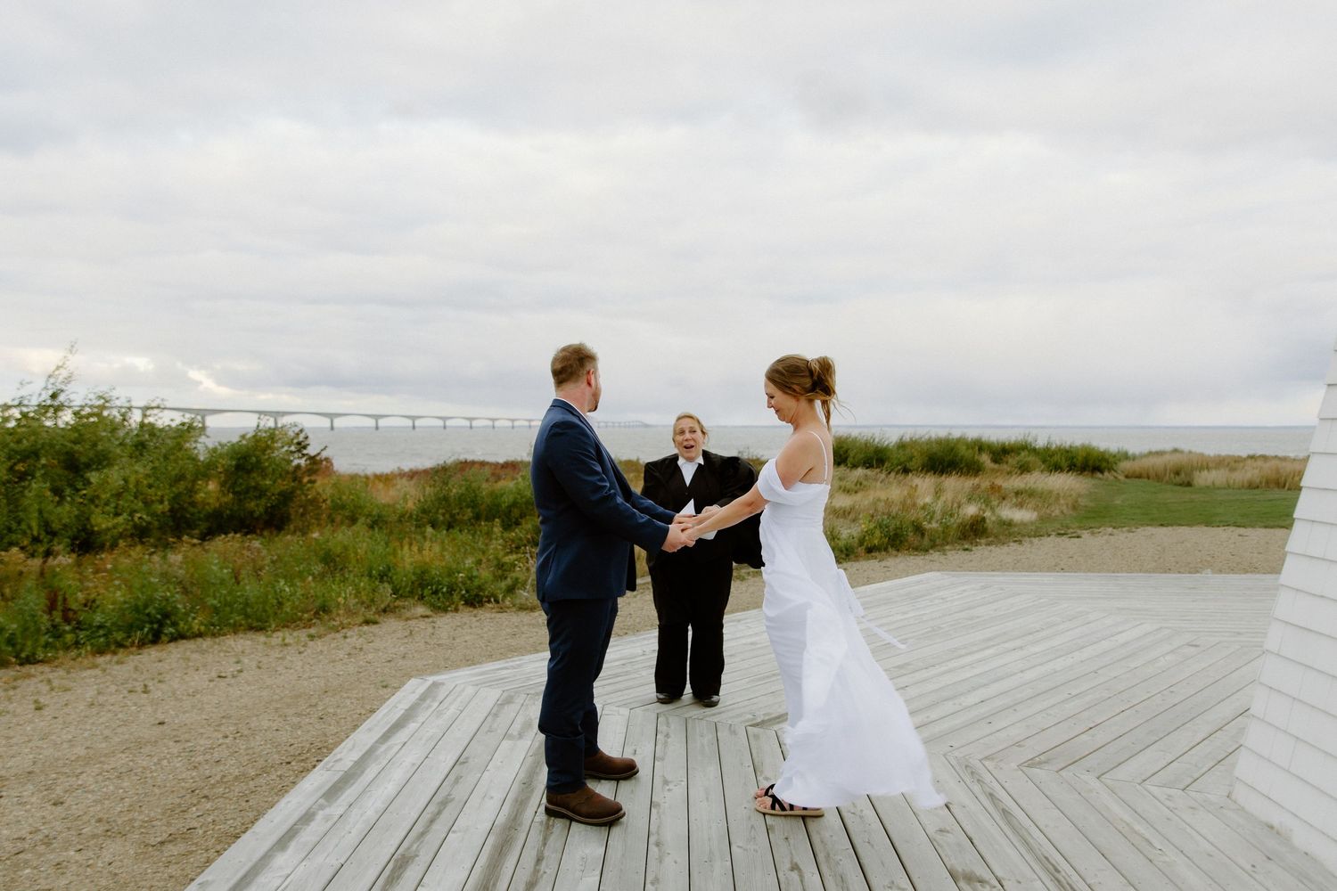 bride and groom exchange vows at outdoor summer wedding Cidery at 51 Acres wedding photography Moncton New Brunswick