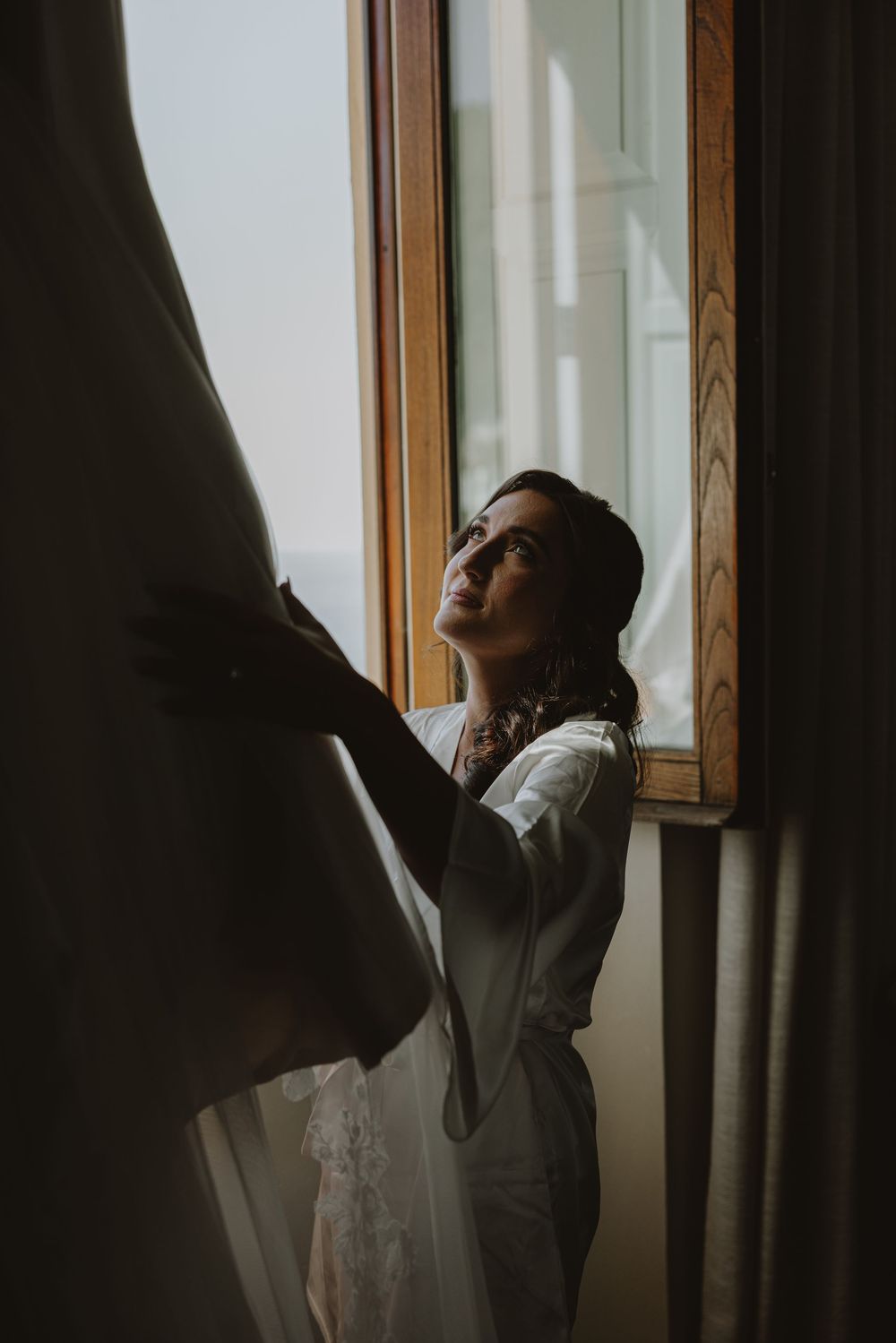 Dramatic window lighting in a moody interior setting.