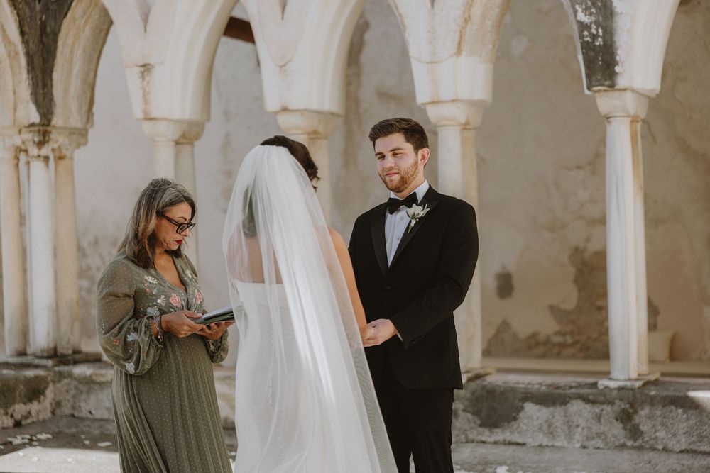 Elegant formal gathering in historic stone archway setting.
