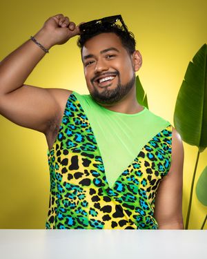 A person in a neon green tank top with leopard print accents poses against a bright yellow background.