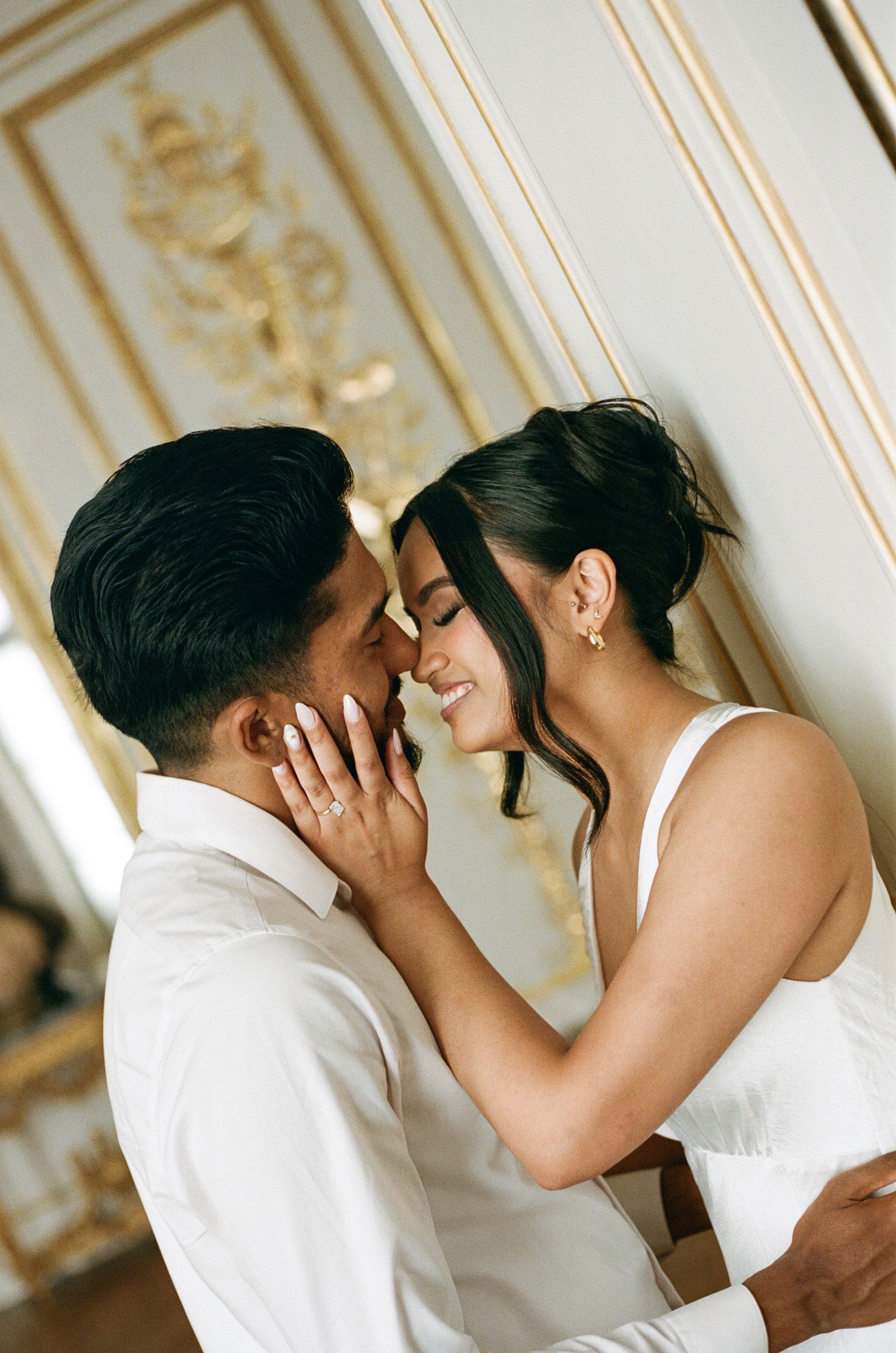 A romantic series of wedding photos showing a couple sharing an intimate kiss in an elegant room with ornate walls.