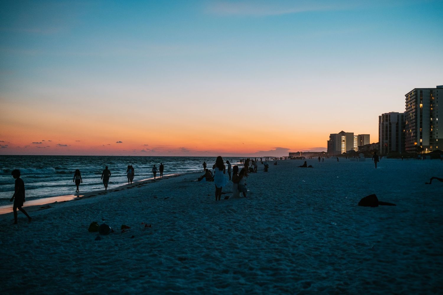 Sunset on the beach in Destin, Florida, with buildings in the distance