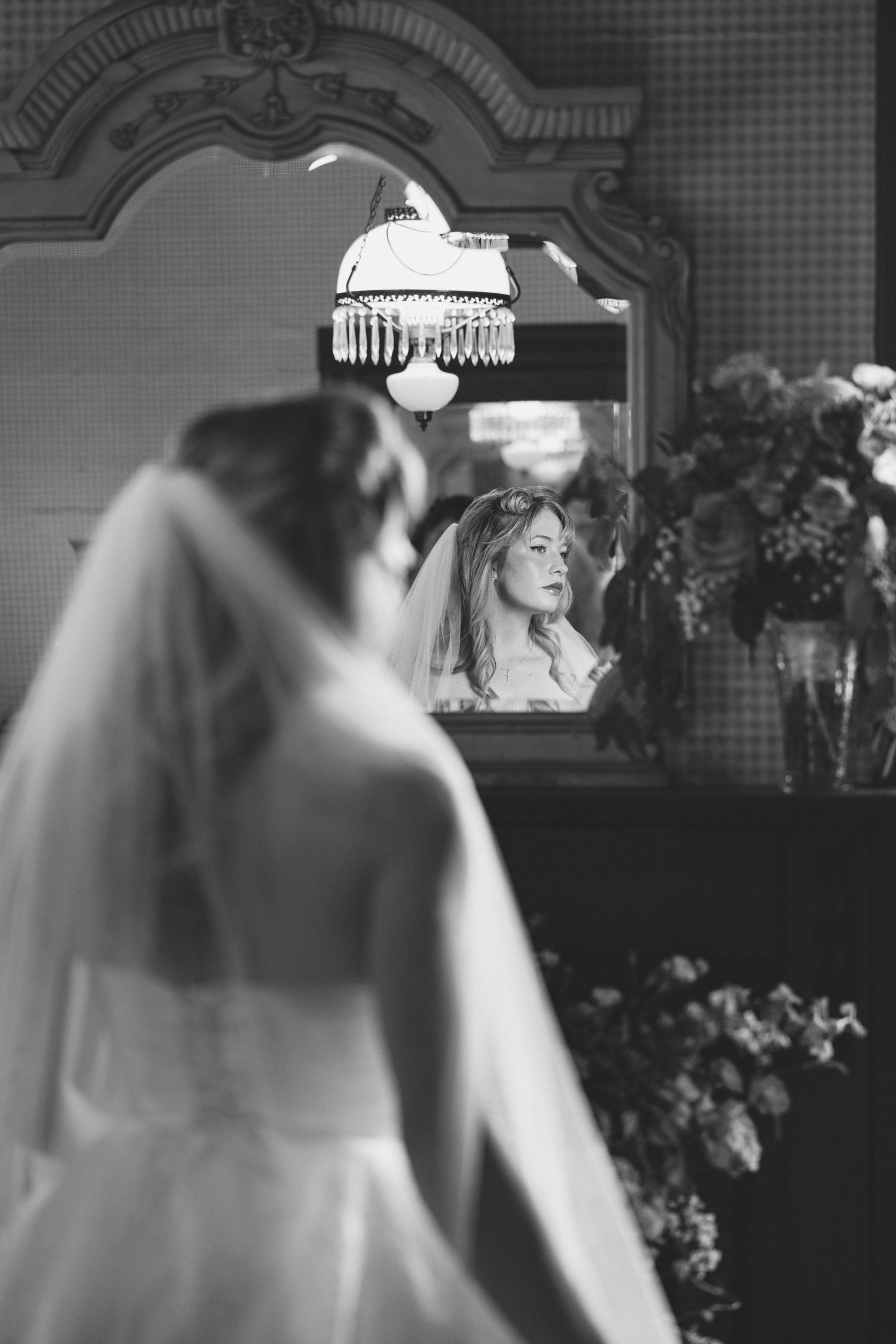 Black and white wedding photo showing a couple dancing together at their reception. East Coast luxury wedding photographer