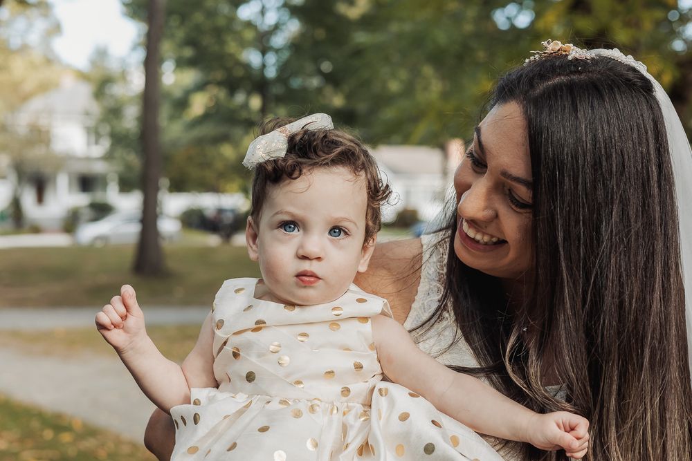 A loving moment shared between parent and child outdoors on a sunny autumn day.
